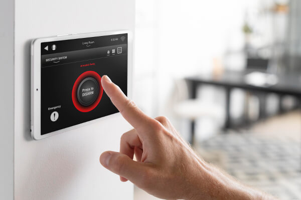 Hand touching a home security touch panel